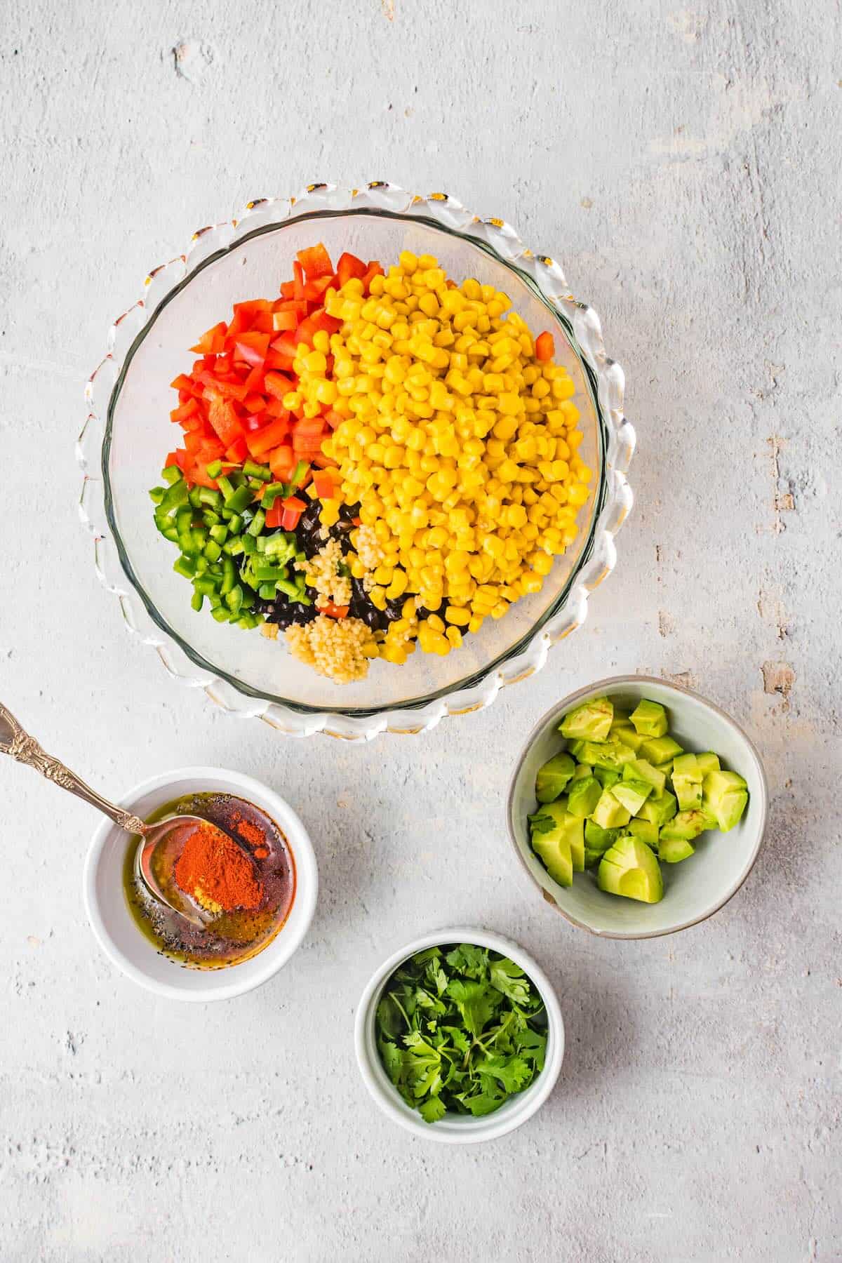 Mixing black beans, corn, peppers together for cowboy caviar dip.