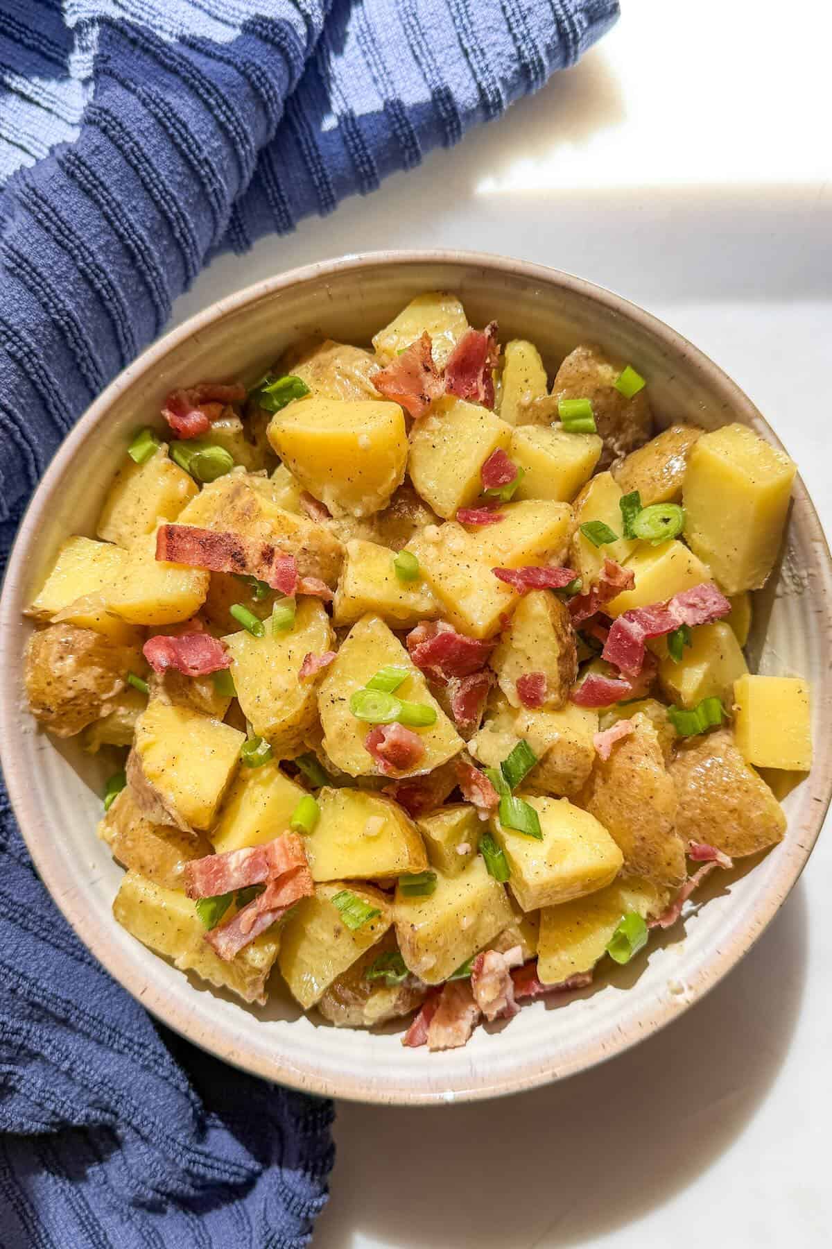Overhead photo of mayo free potato salad with Yukon gold potatoes, bacon, and green onions.