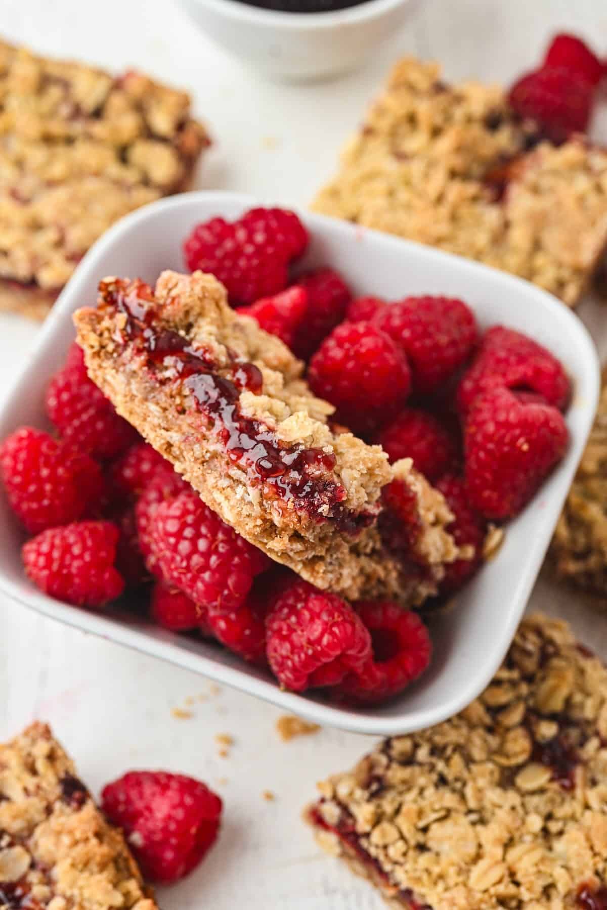 Easy raspberry oatmeal bars made with raspberry jam, oats, and a buttery crumble topping.