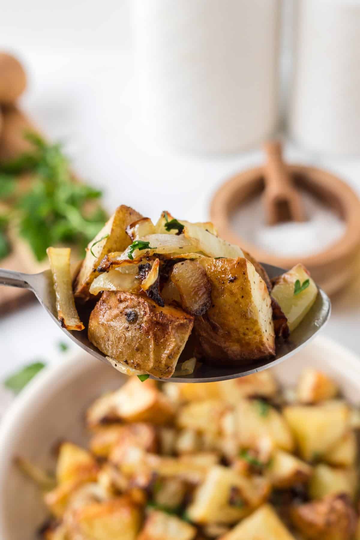 Crispy air fryer breakfast potatoes and onions served with fresh parsley.