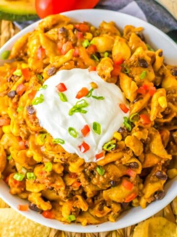 Overhead view of cheesy crockpot taco pasta made with ground beef, black beans, corn, and pasta.