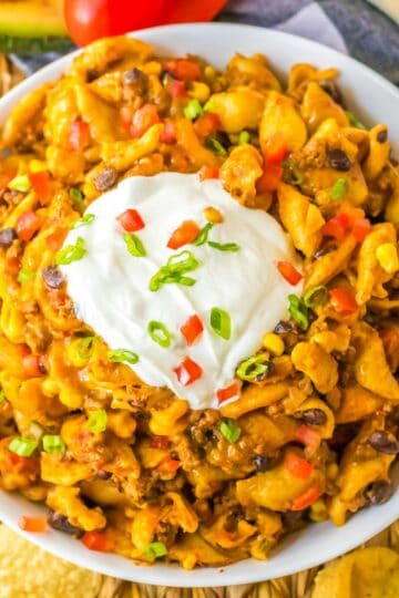 Overhead view of cheesy crockpot taco pasta made with ground beef, black beans, corn, and pasta.