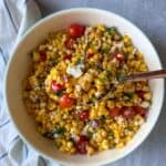 A summer salad made with sweet corn, tomatoes, feta cheese and a simple homemade dressing.