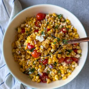 A summer salad made with sweet corn, tomatoes, feta cheese and a simple homemade dressing.