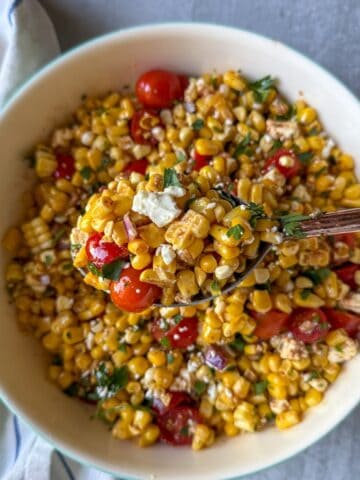A summer salad made with sweet corn, tomatoes, feta cheese and a simple homemade dressing.