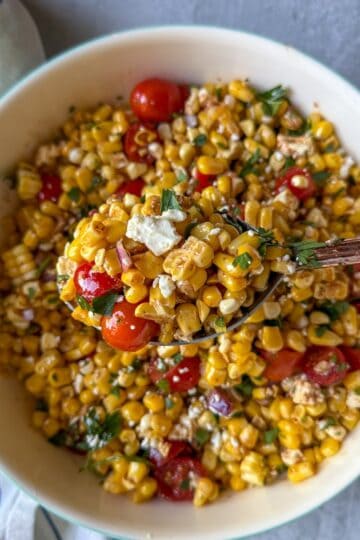 A summer salad made with sweet corn, tomatoes, feta cheese and a simple homemade dressing.