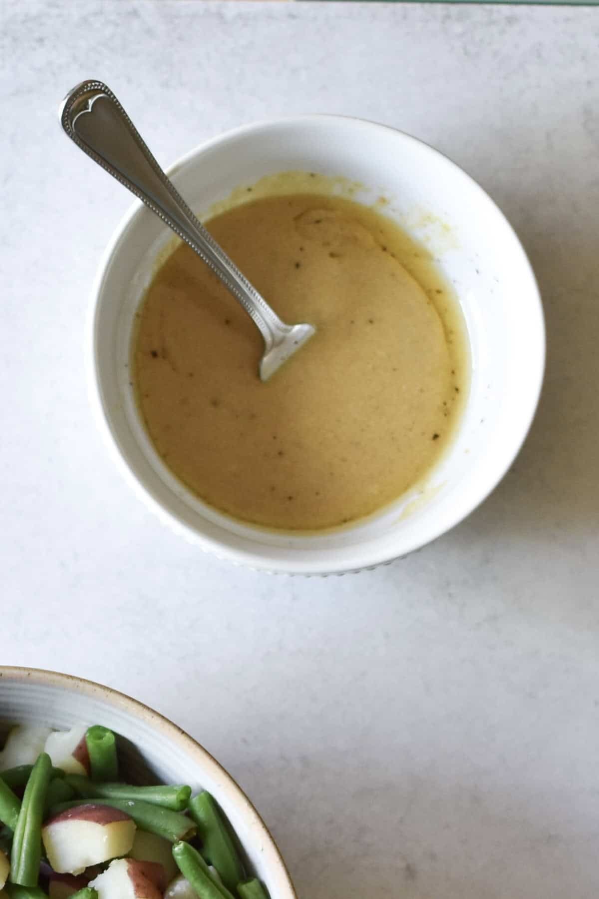 A vinegar and Dijon dressing combined to top warm potatoes and green beans.