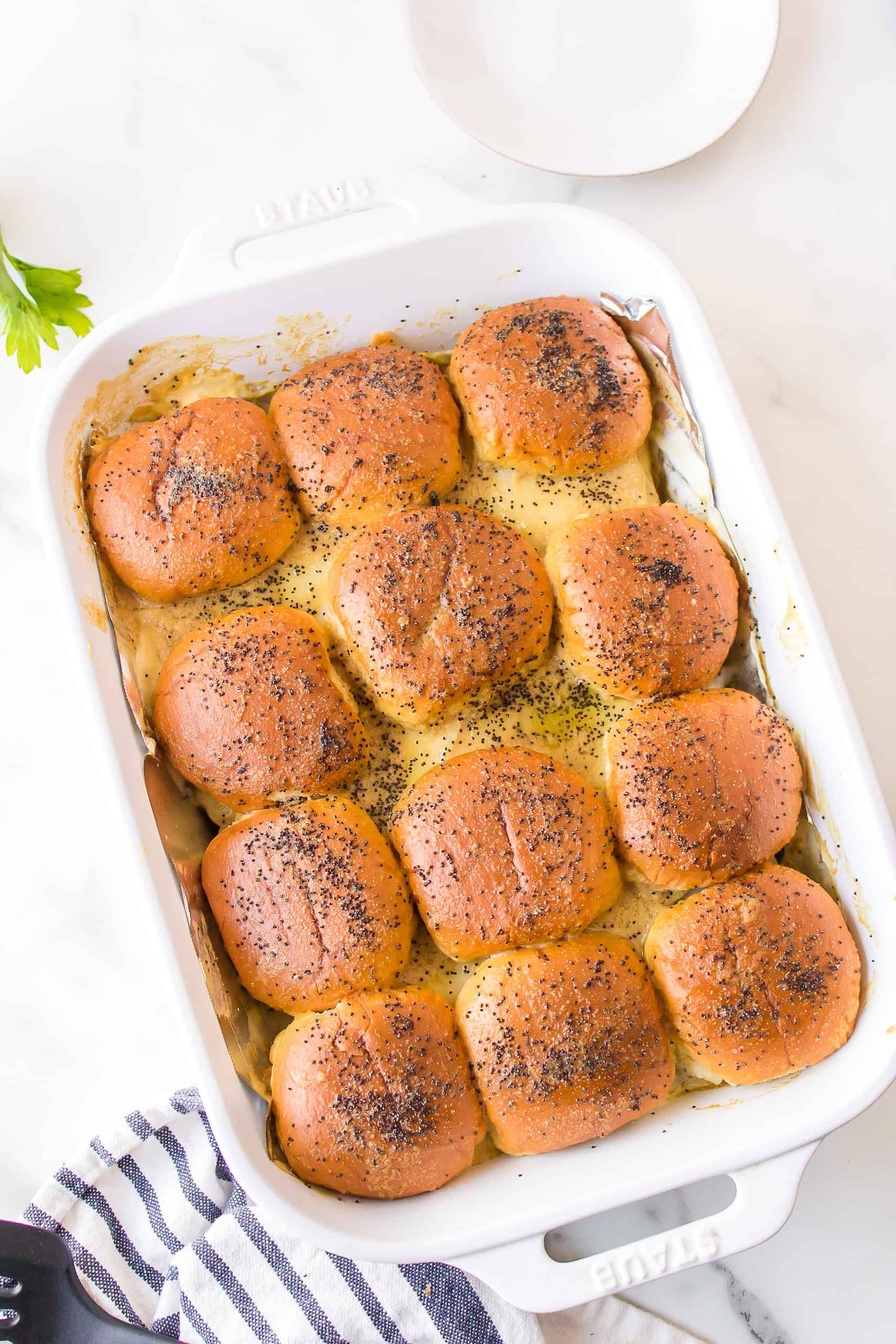 Freshly baked roast beef sliders with golden brown Hawaiian rolls.