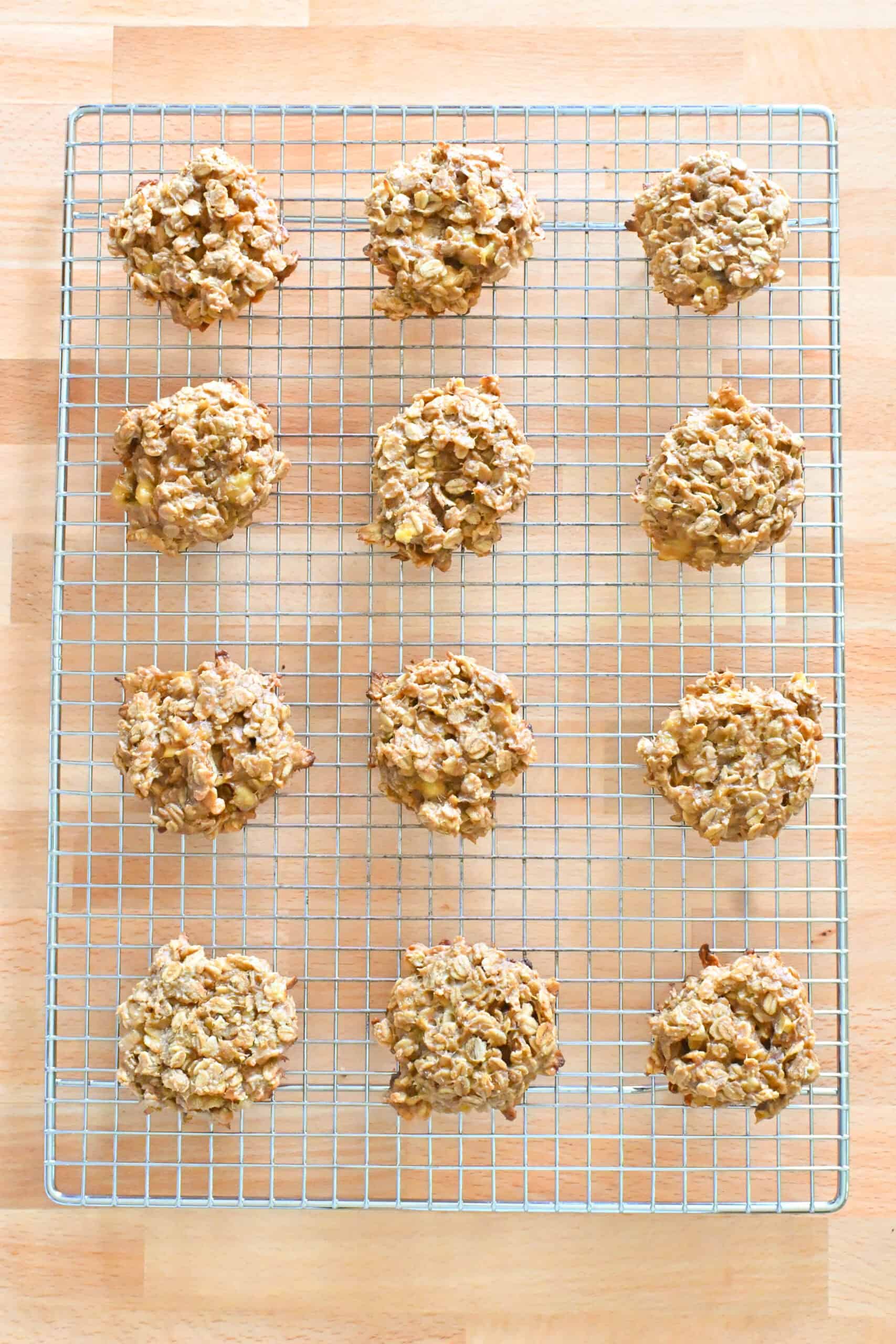 Freshly baked banana oatmeal breakfast cookies cooling on a wire rack.
