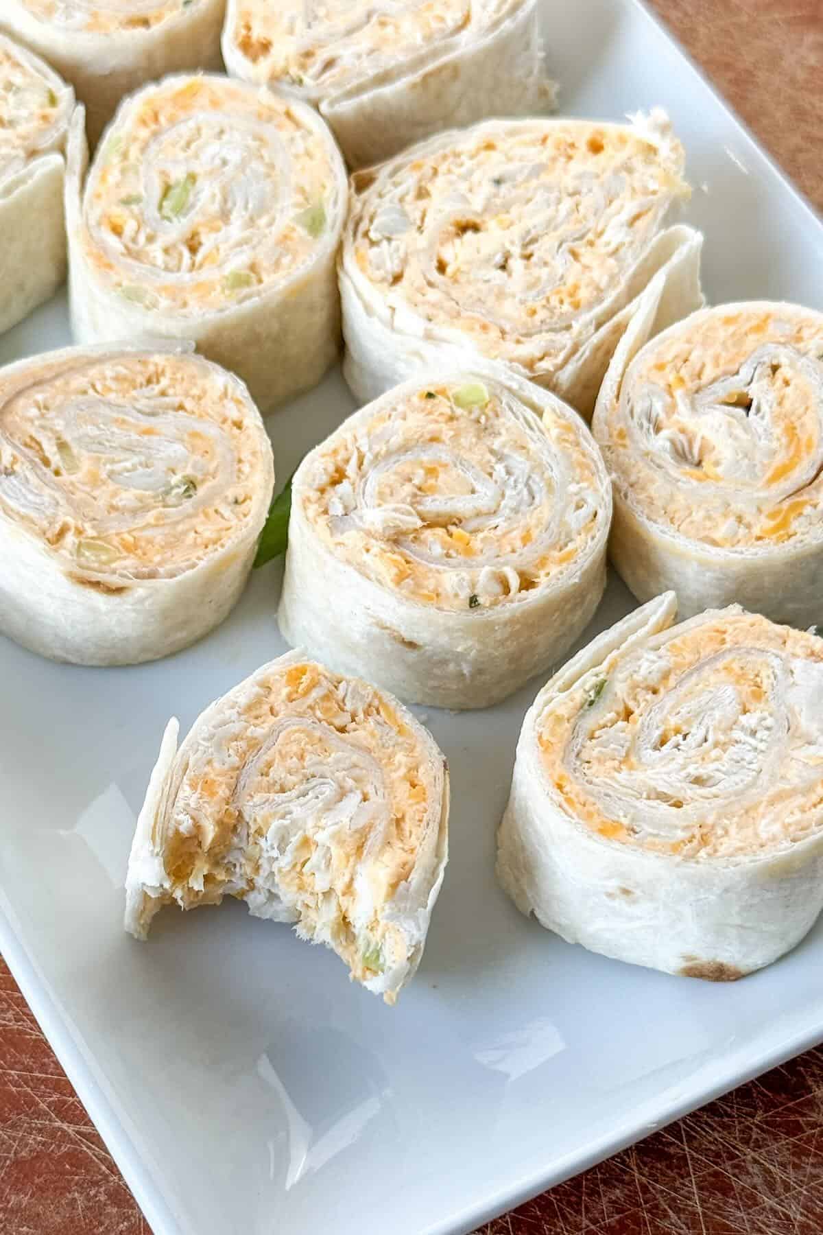 Sliced buffalo chicken ranch pinwheels in bite-sized appetizer pieces.