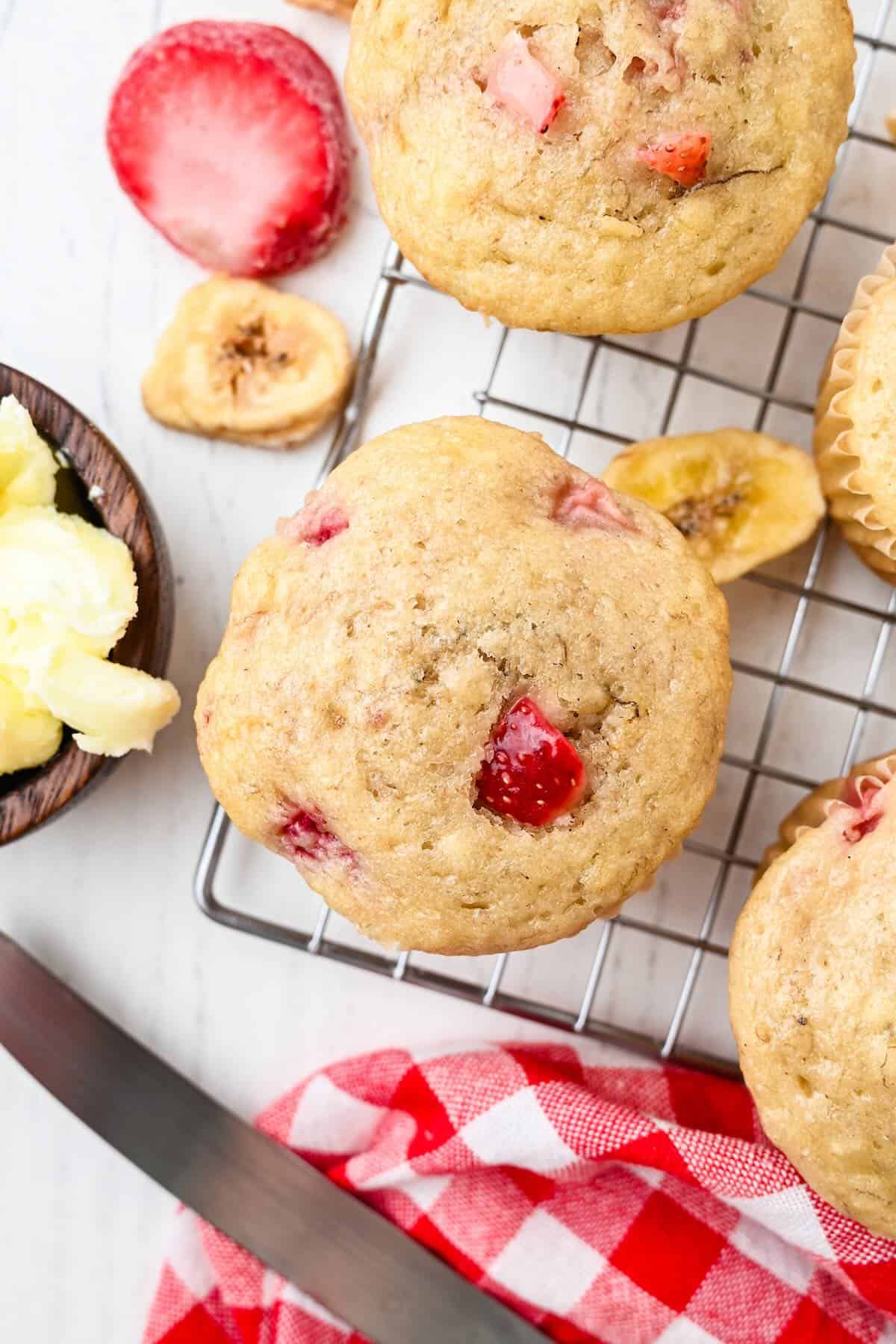 Homemade strawberry banana muffins with visible strawberry pieces and golden tops.