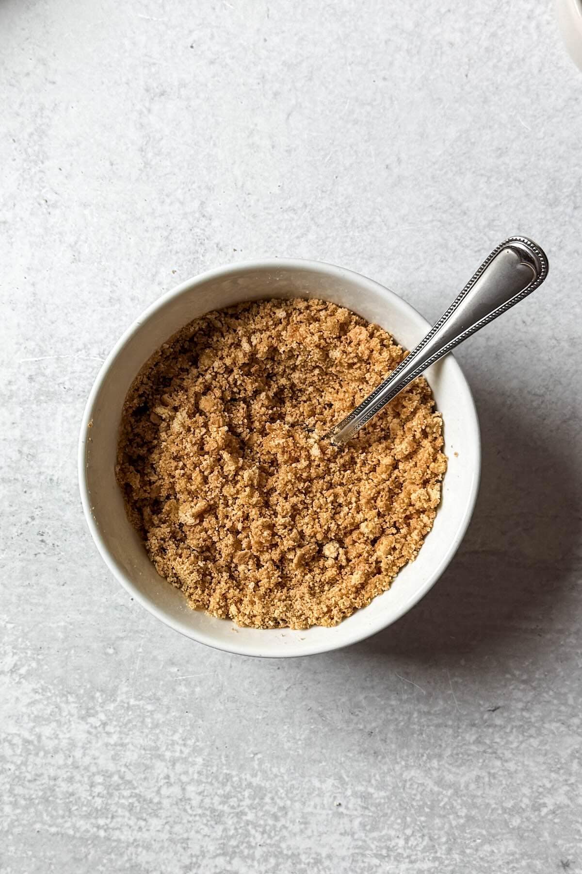 Graham cracker crumb layer for the bottom of a parfait glass.