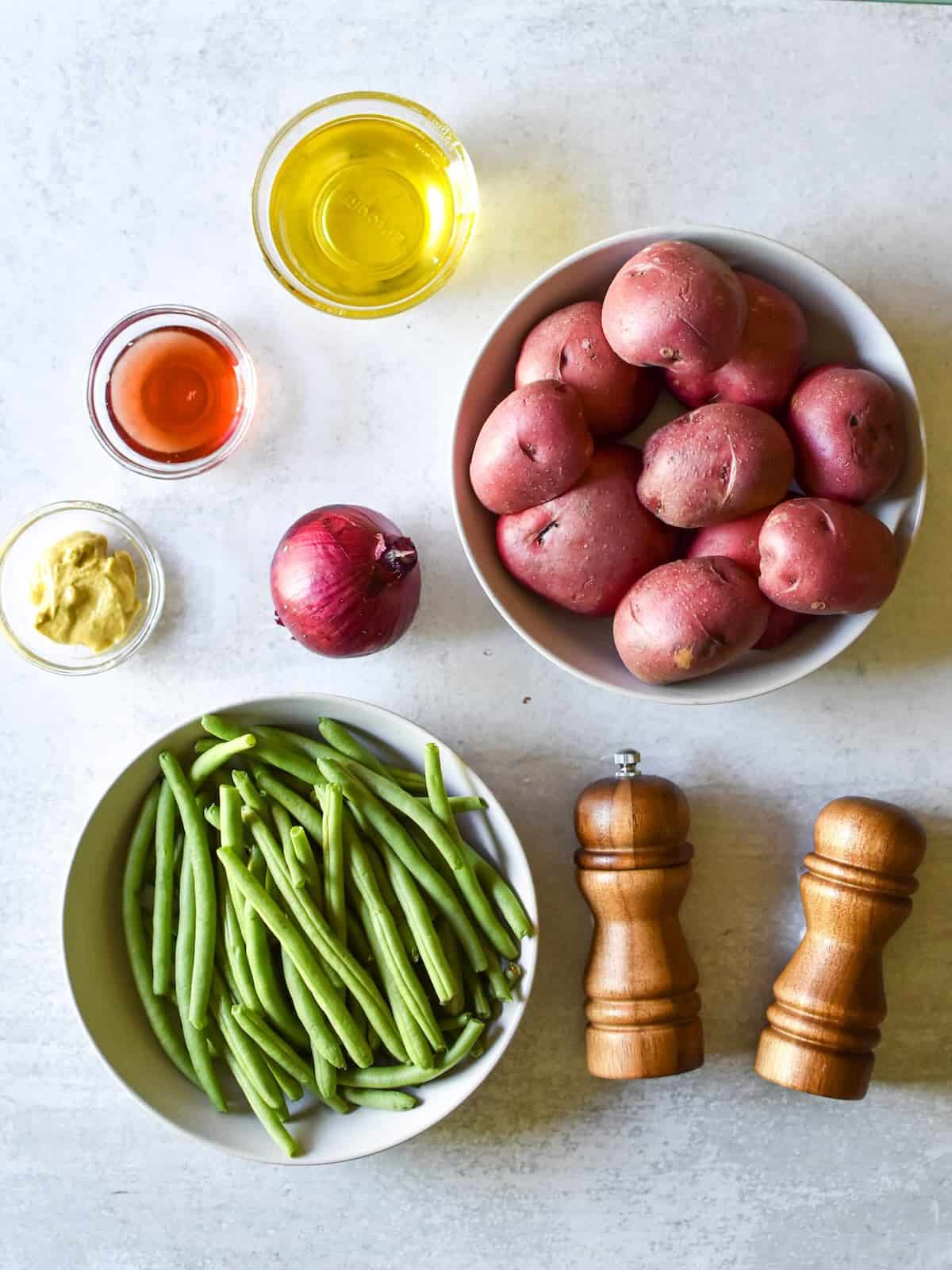 Red potatoes, green beans, red wine vinegar, olive oil, Dijon mustard and salt and pepper to make a green bean potato salad.