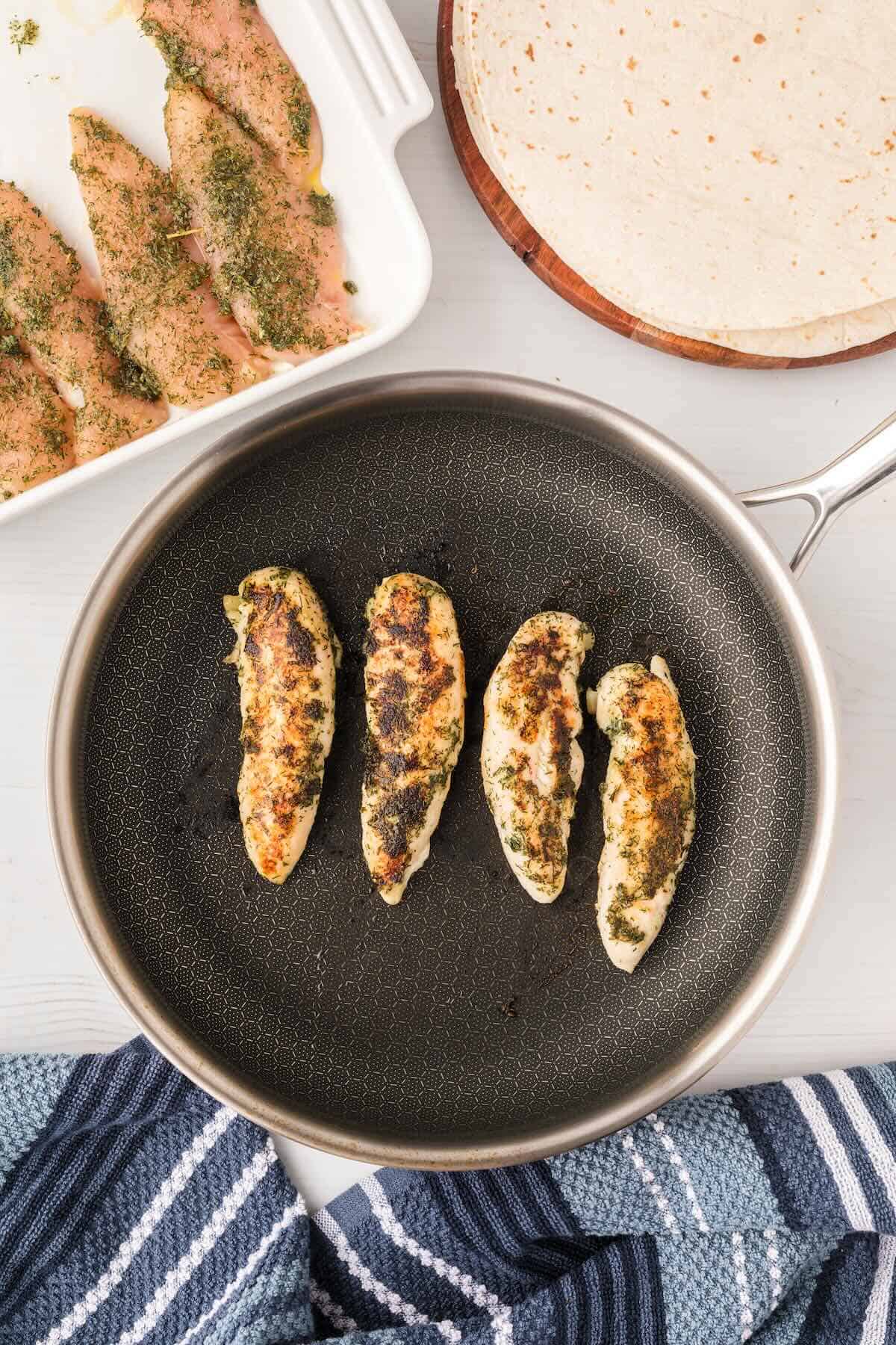 Cooked chicken tenders ready to be used in chicken bacon ranch wraps.