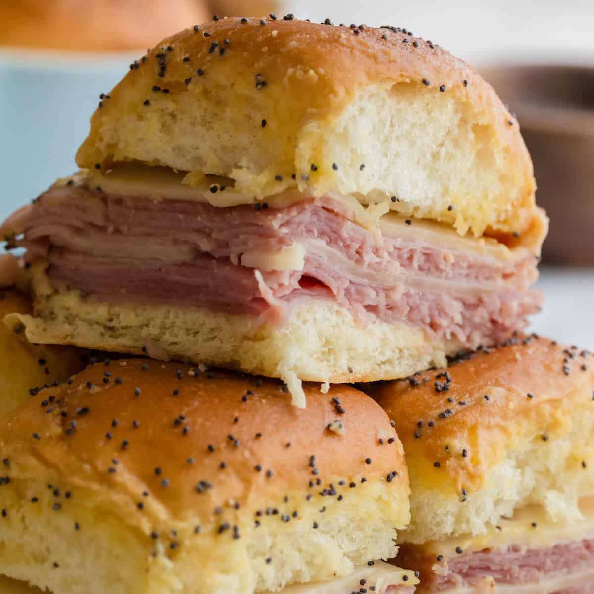 Ham and cheese sliders recipe made with Hawaiian rolls, ham, Swiss cheese, and buttery Dijon topping.