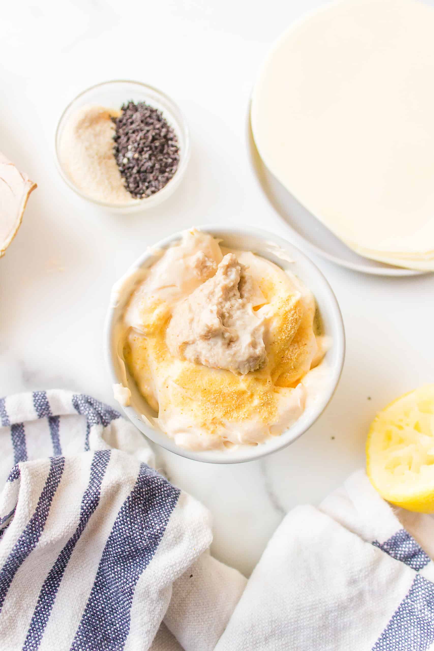 A bowl with horseradish sauce for roast beef sliders.