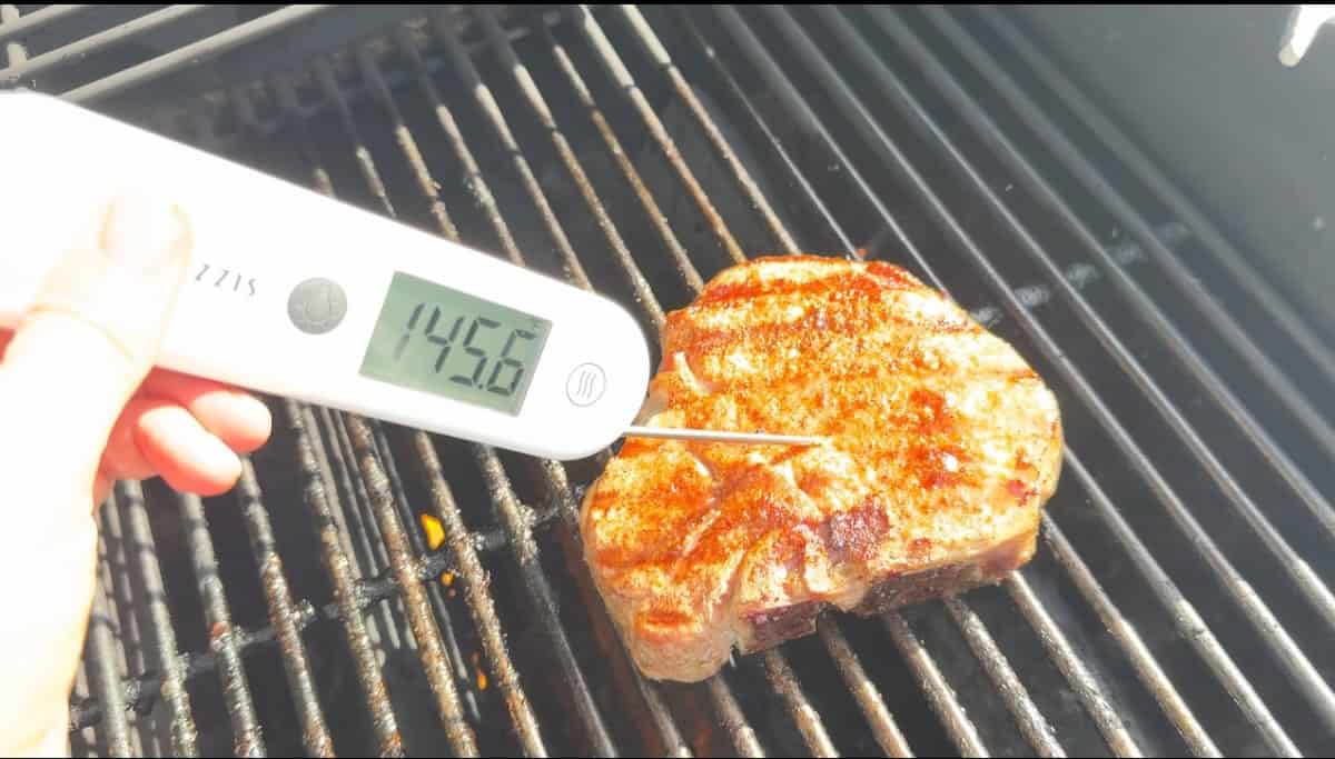 Close-up of a juicy grilled pork chop sliced to show the tender interior.