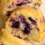 Close-up slice of lemon blueberry bundt cake made with cake mix showing moist crumb and fresh blueberries.