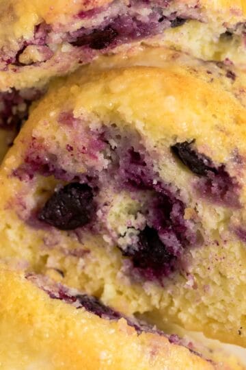 Close-up slice of lemon blueberry bundt cake made with cake mix showing moist crumb and fresh blueberries.