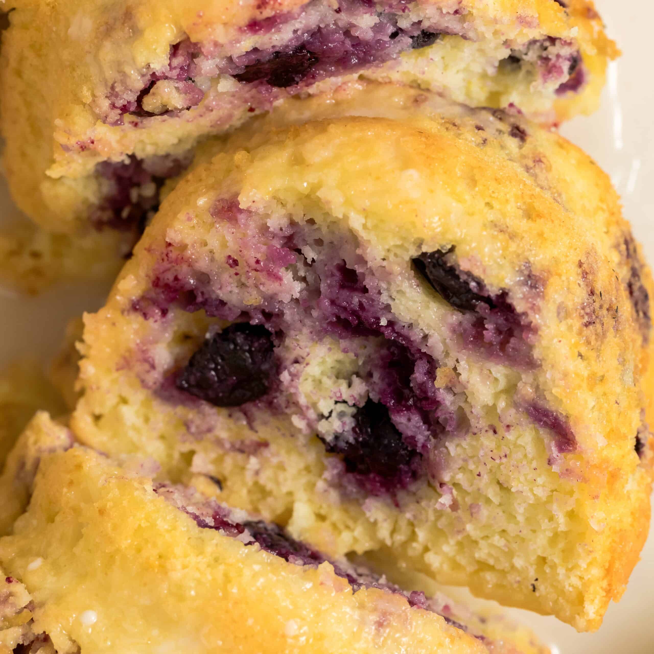 Close-up slice of lemon blueberry bundt cake made with cake mix showing moist crumb and fresh blueberries.