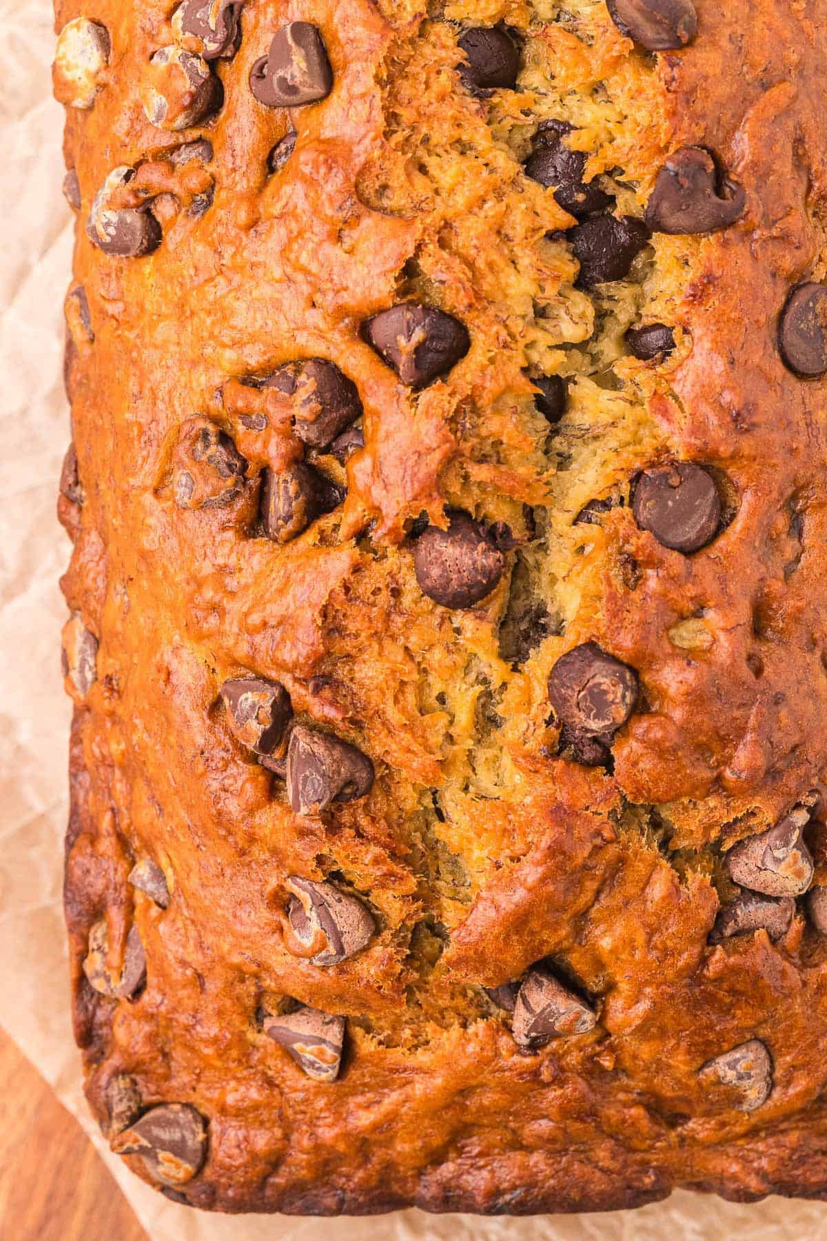 Close-up of moist chocolate chip banana bread with chunks of chocolate in every slice.