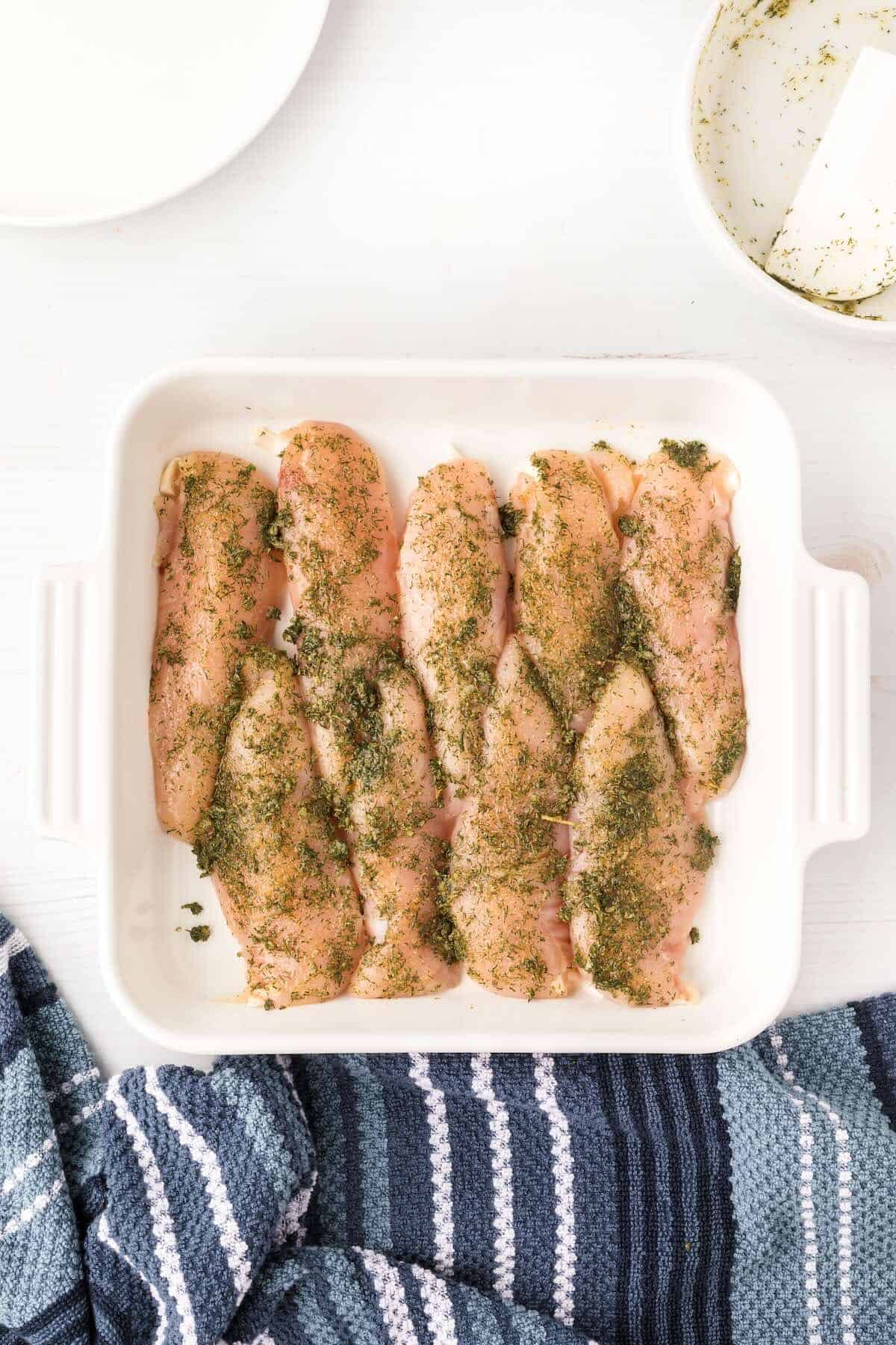 Chicken tenders coated in ranch seasoning before cooking.