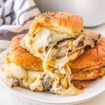 Roast beef sliders on Hawaiian rolls with provolone cheese and horseradish sauce.