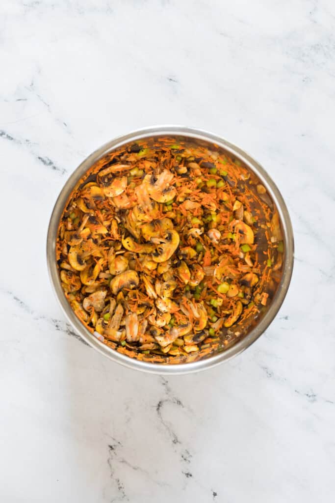 Carrots, celery, onion, mushrooms, and garlic cooking in the Instant Pot before adding the rice.