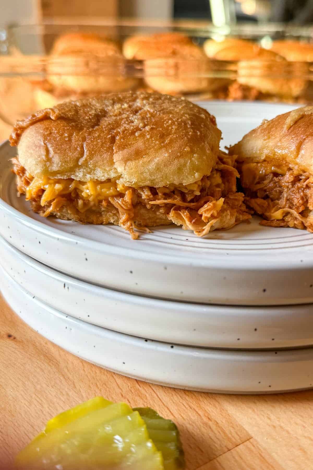 Single shredded BBQ chicken slider served on a plate.