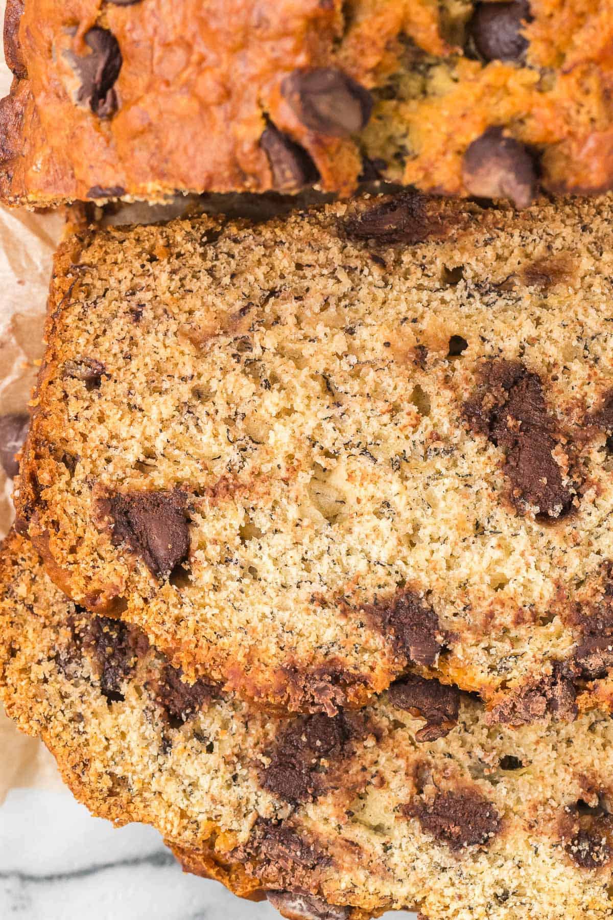 Slices of chocolate chip banana bread showing melted chocolate chips throughout the loaf.