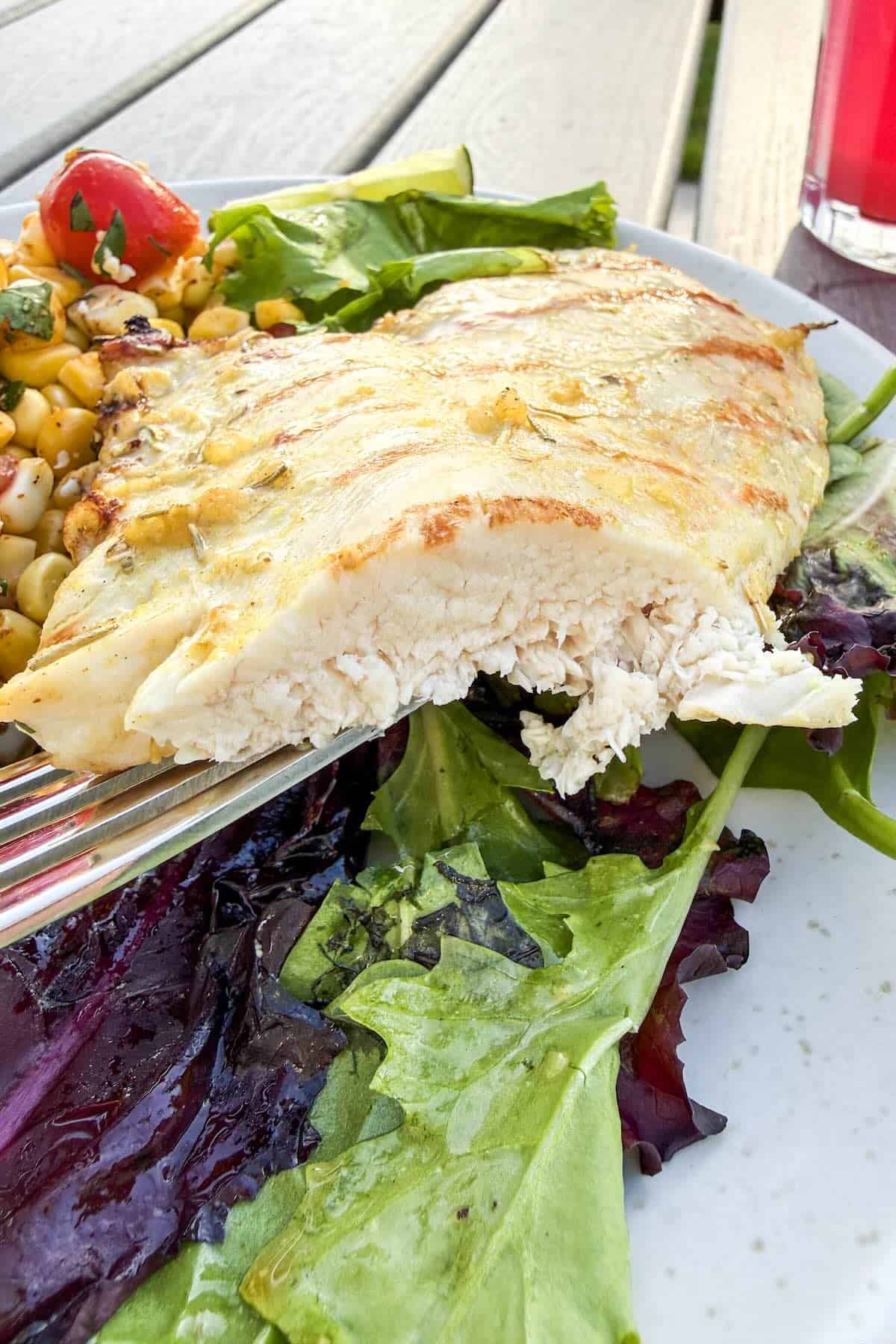 Juicy sliced herb grilled chicken breast served for an easy summer dinner.