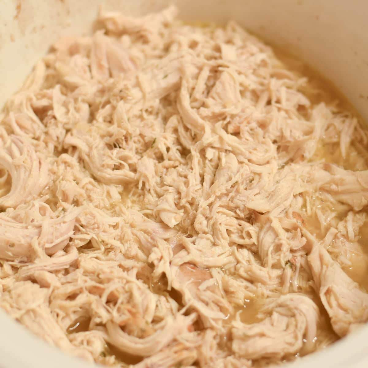 Tender slow cooker shredded chicken made with chicken breasts and simple seasonings.