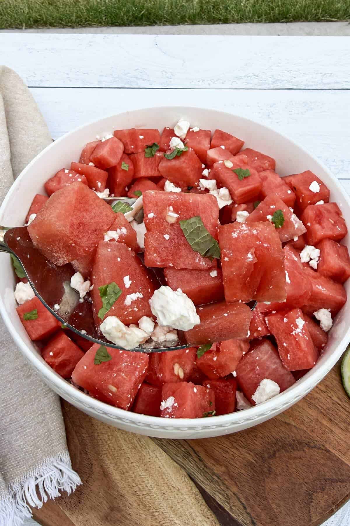 Spoonful of watermelon feta salad ready to serve.