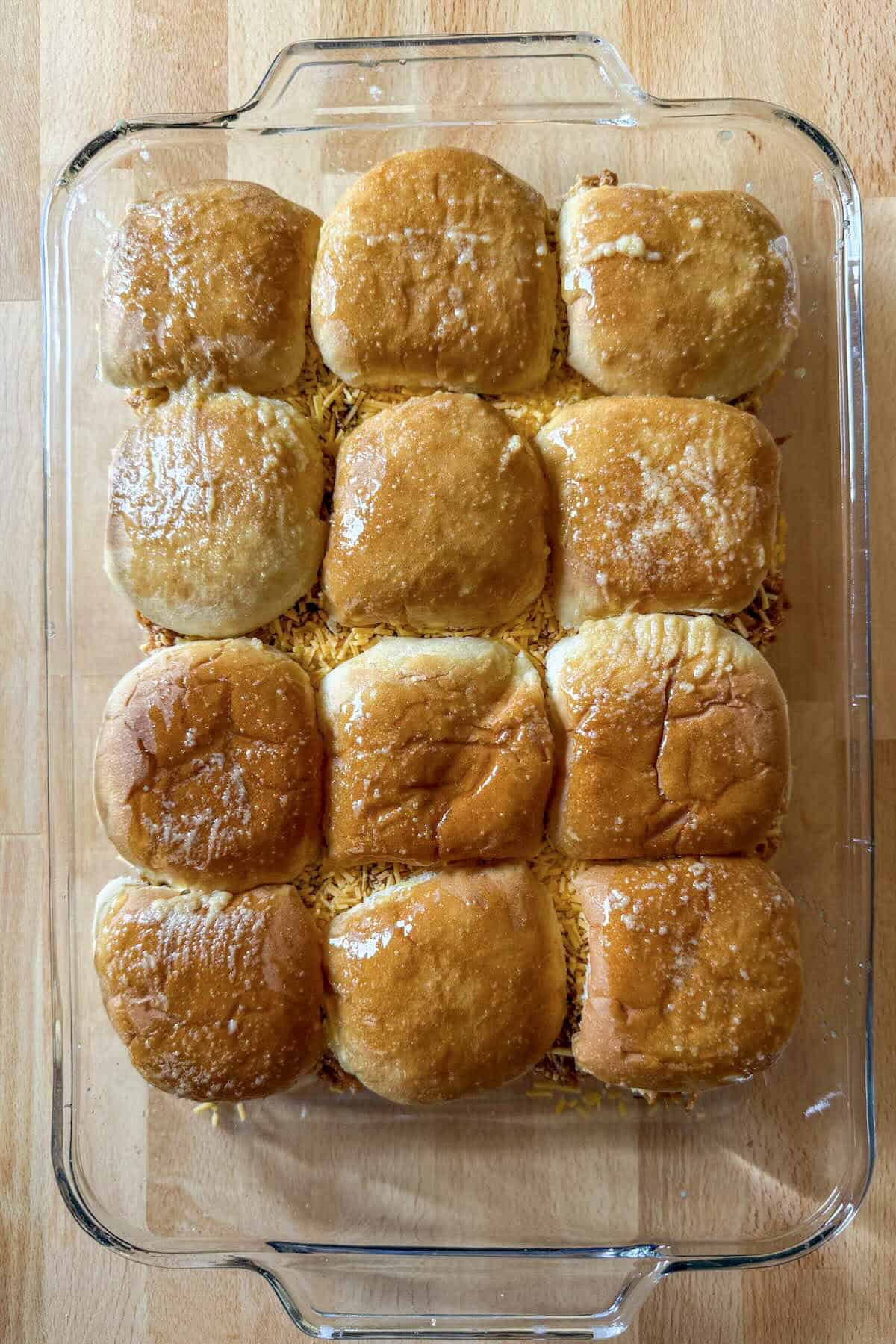 Baked chicken bbq sliders in a casserole dish.