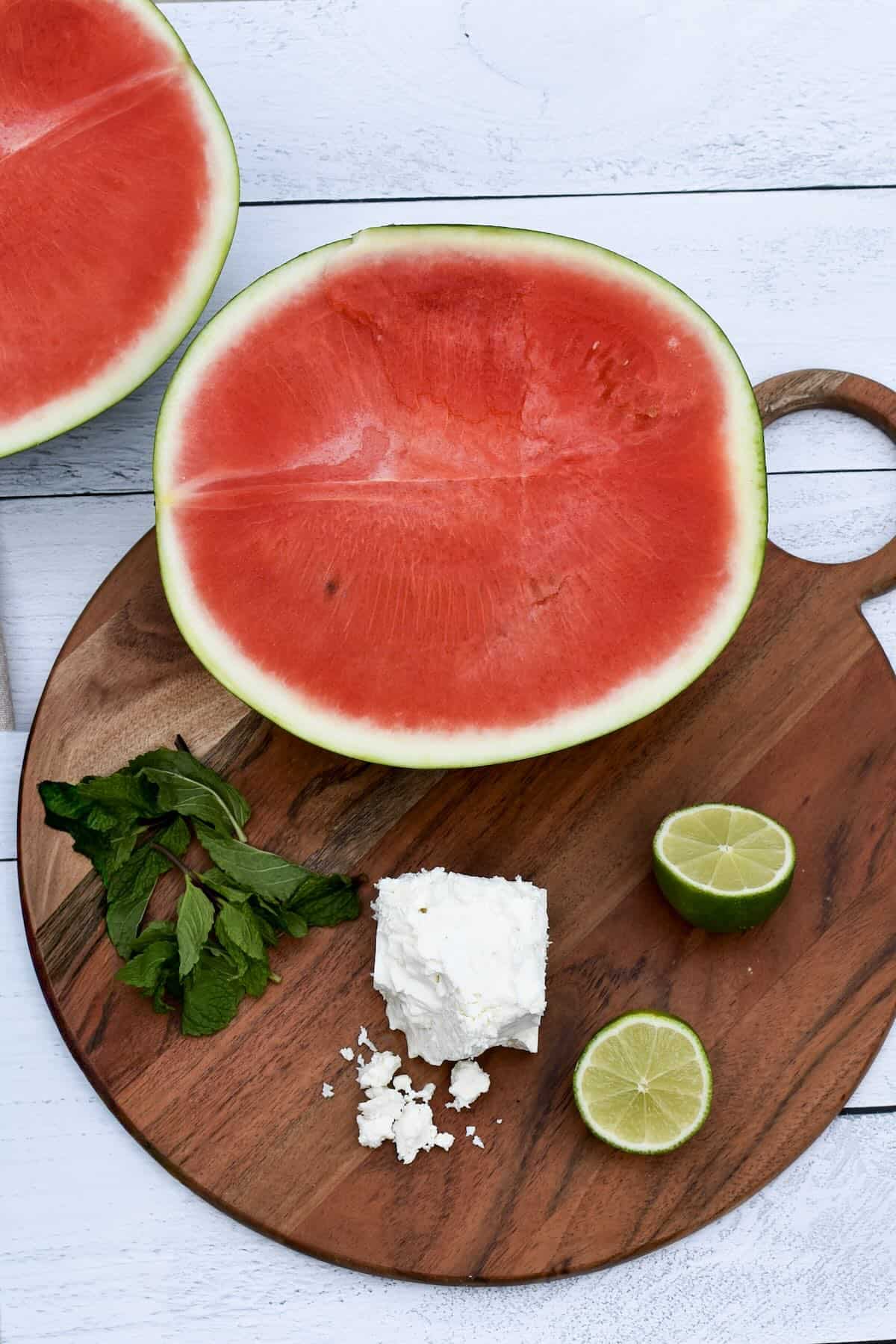 Watermelon, fresh mint, feta cheese and limes to make a refreshing summer salad.