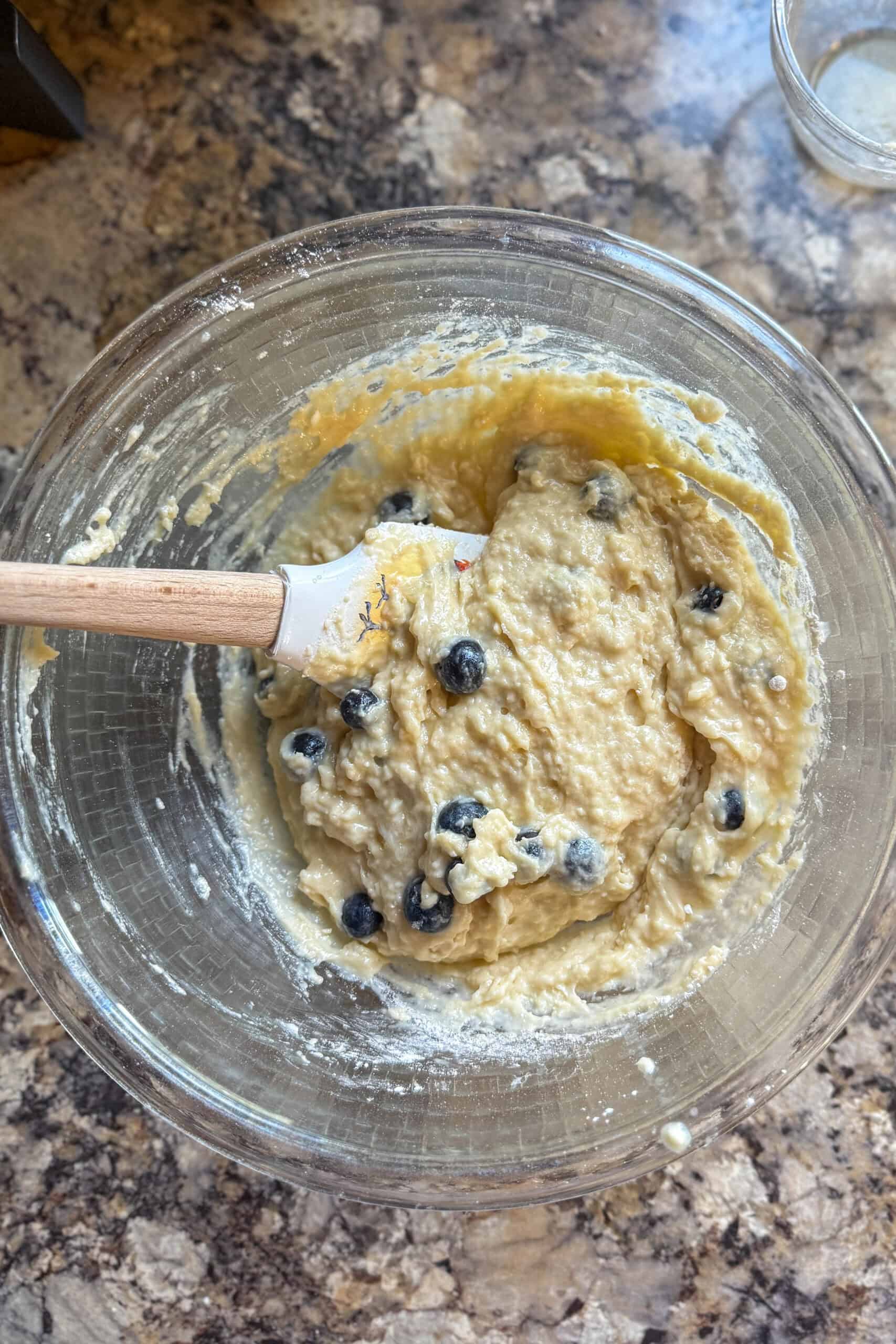Fresh blueberries folded into muffin batter.