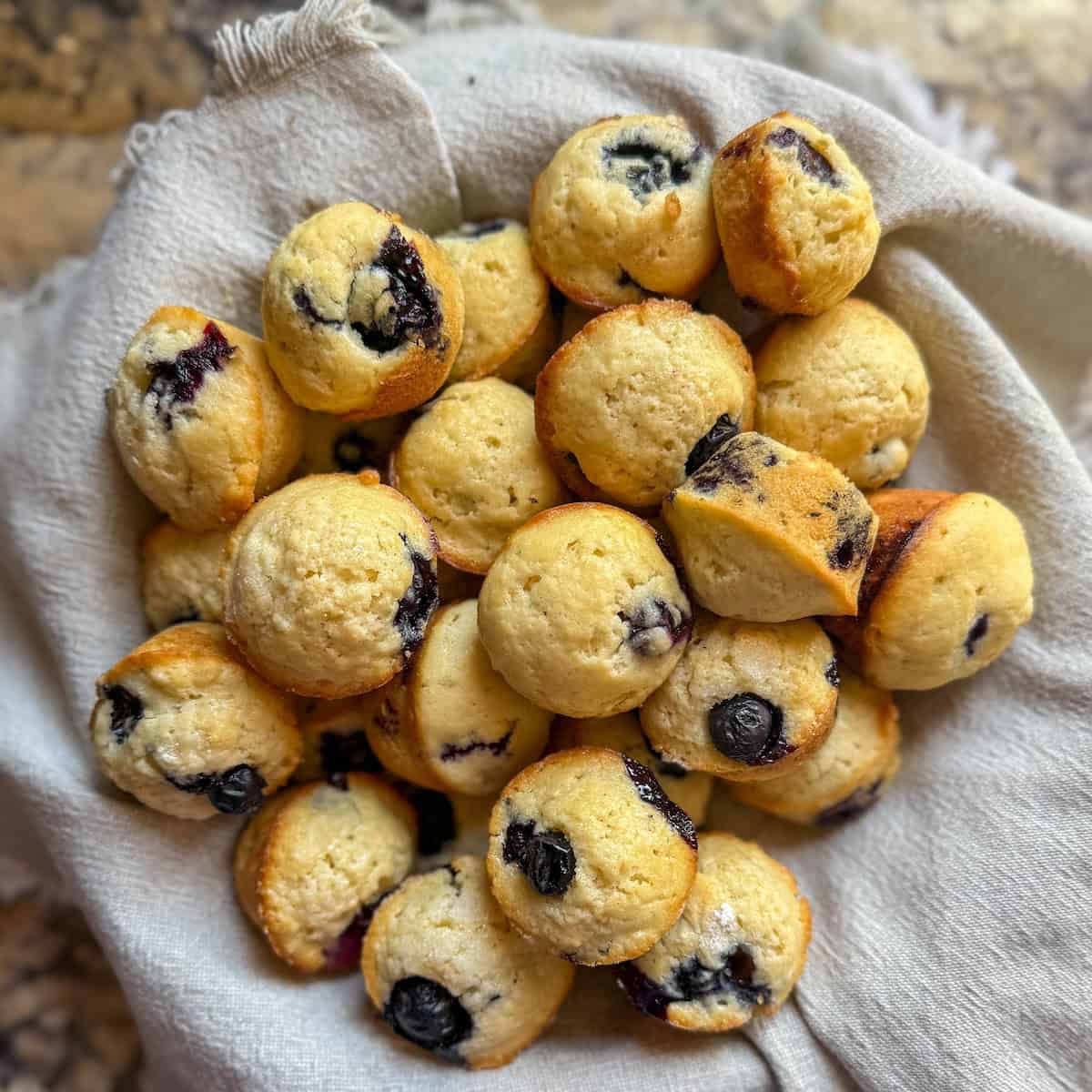 Easy homemade mini blueberry muffins served in a basket.