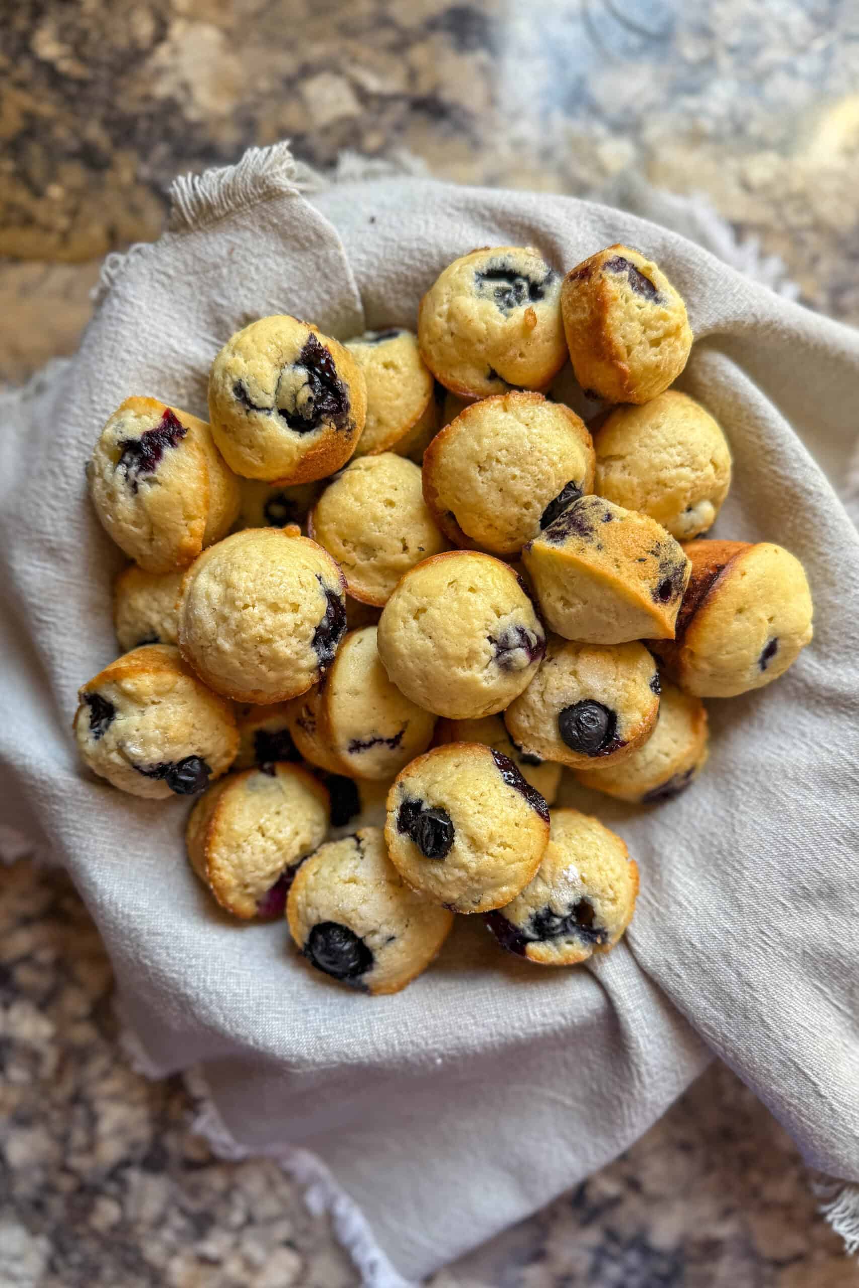 Easy homemade mini blueberry muffins served in a basket.