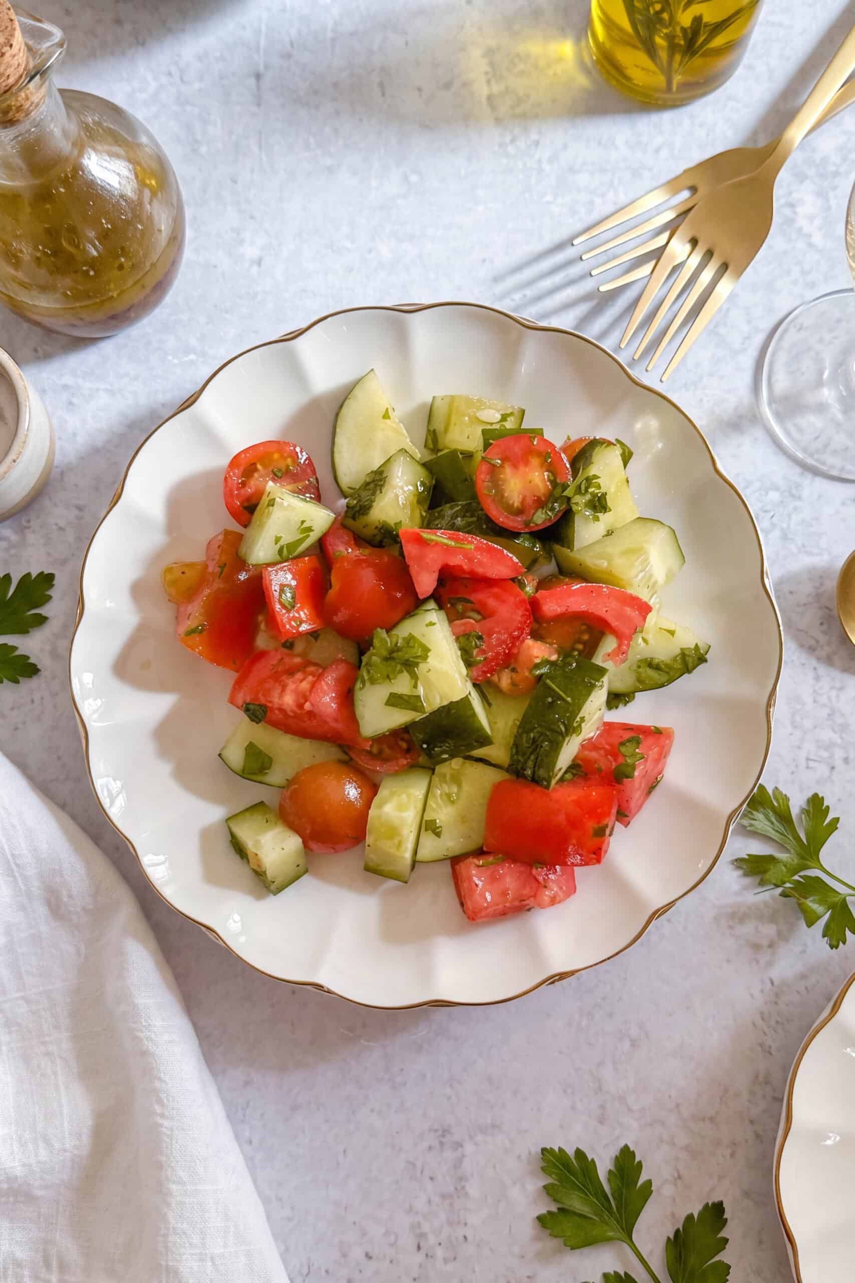Easy cucumber tomato salad made with fresh tomatoes, cucumbers, parsley, olive oil, and lemon juice.