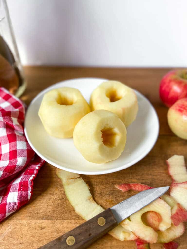 Apples that have been peeled and cored before slicing.