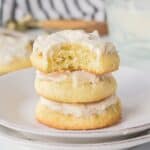 A stack of soft sour cream cookies with buttercream frosting.